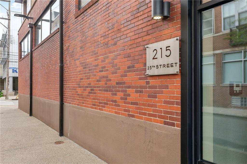 215 25th Street, Unit 7 Pittsburgh, PA 15222 - Photo 49 of 49 a brick building with a street sign on a wall