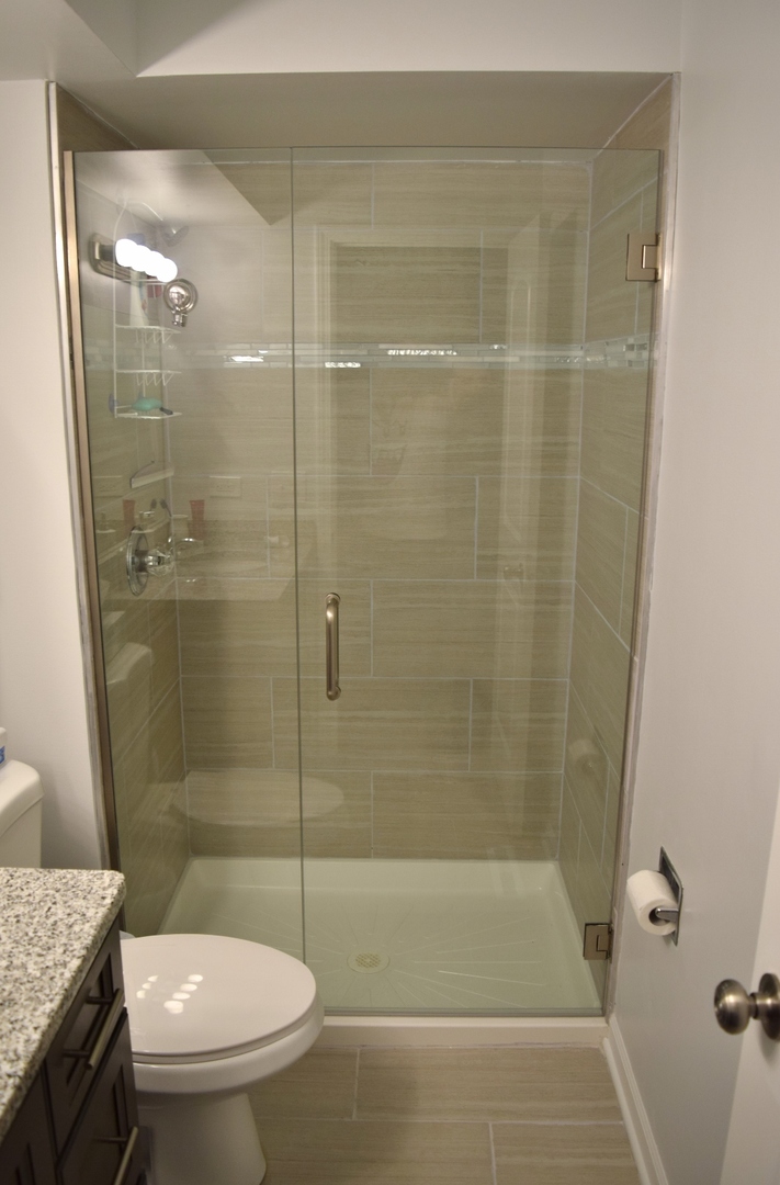 1905 West Golf Road, Unit 1A Mount Prospect, IL 60056 - Photo 13 of 24 a bathroom with a shower and a toilet