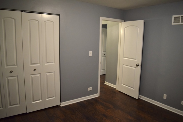 1905 West Golf Road, Unit 1A Mount Prospect, IL 60056 - Photo 17 of 24 a view of an empty room with wooden floor