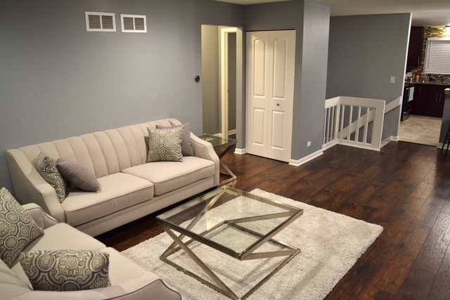 1905 West Golf Road, Unit 1A Mount Prospect, IL 60056 - Photo 3 of 24 a living room with furniture and wooden floor