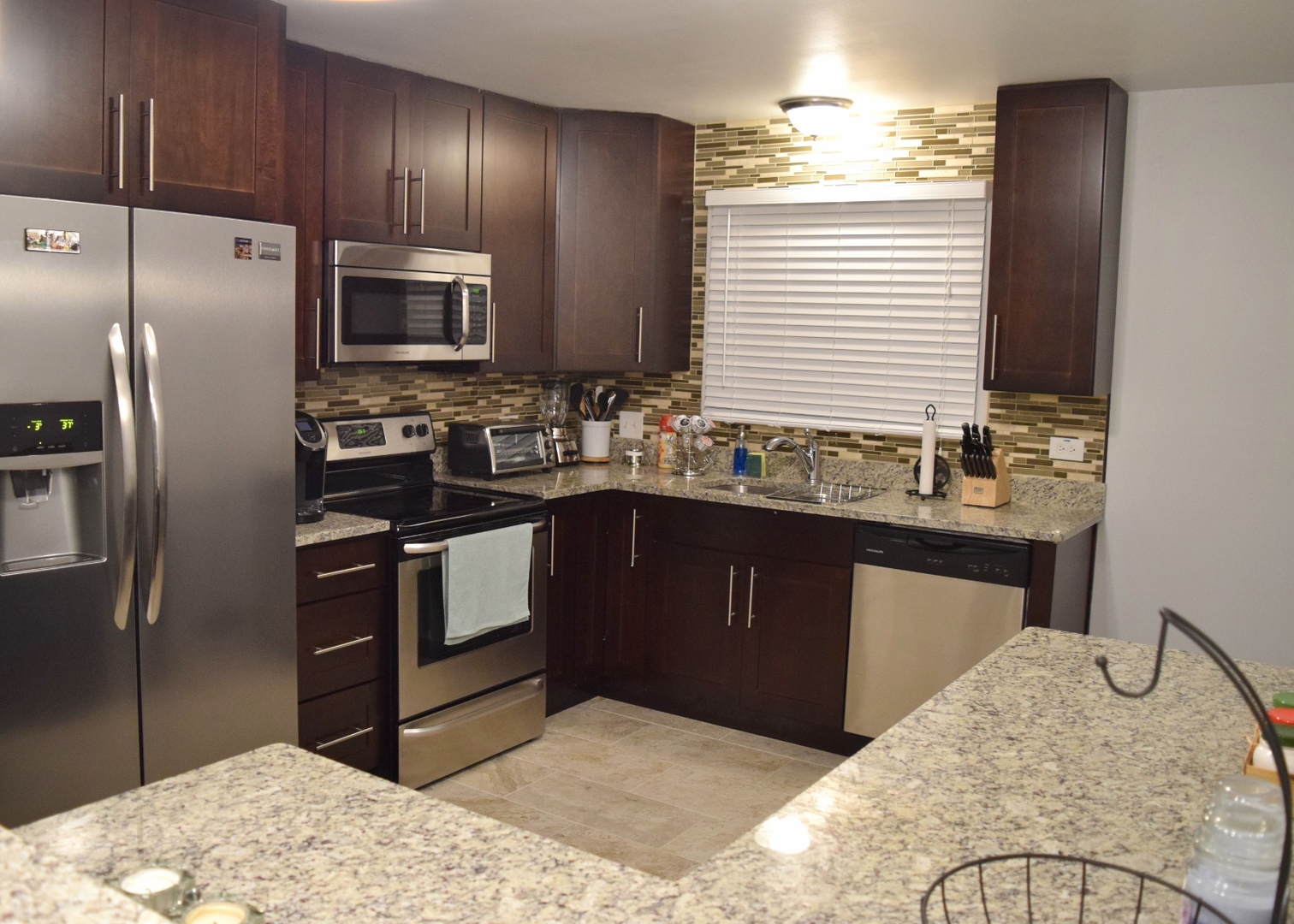1905 West Golf Road, Unit 1A Mount Prospect, IL 60056 - Photo 6 of 24 a kitchen with a sink refrigerator and microwave