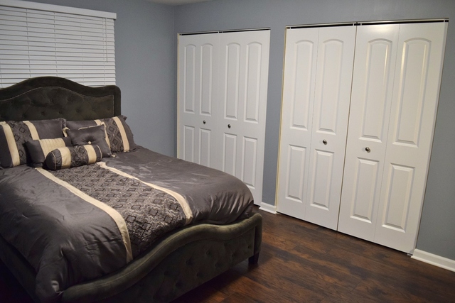 1905 West Golf Road, Unit 1A Mount Prospect, IL 60056 - Photo 10 of 24 a bedroom with a bed and a mirror