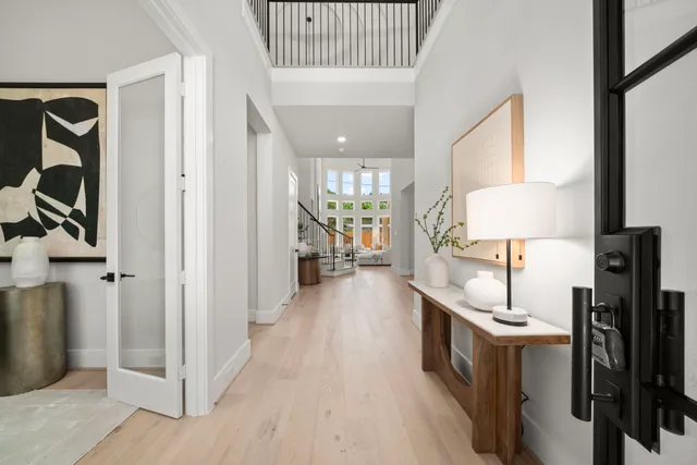 a living room with furniture a large window and a sink