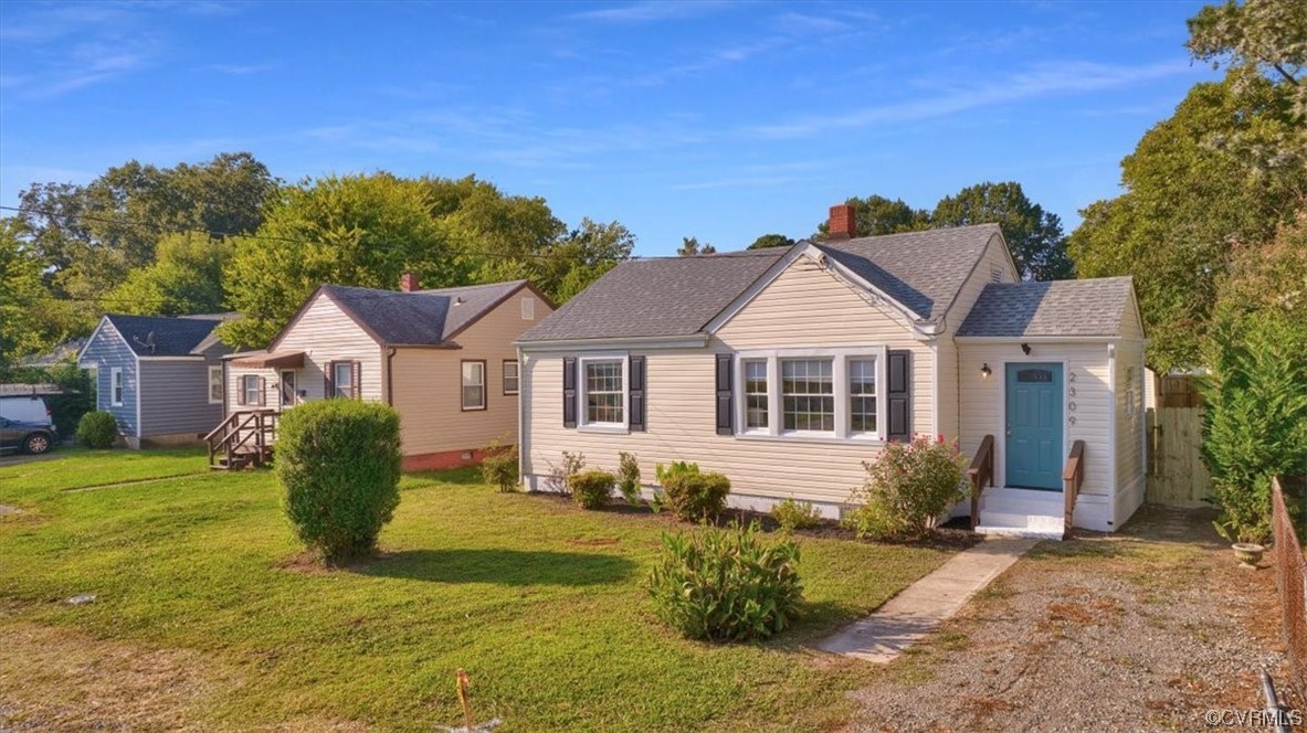 2309 Wright Avenue Richmond, VA 23224 - Photo 2 of 39 a front view of a house with a garden and yard