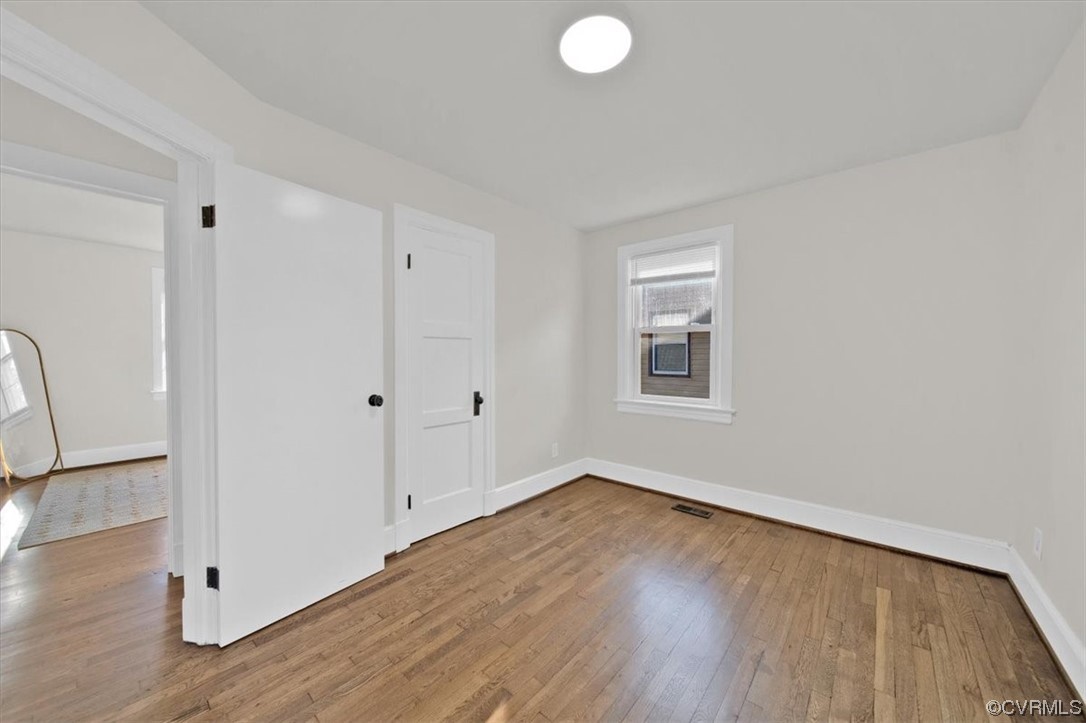2309 Wright Avenue Richmond, VA 23224 - Photo 22 of 39 a view of an empty room with wooden floor and a window