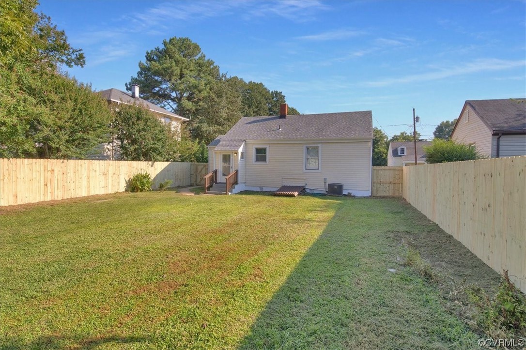 2309 Wright Avenue Richmond, VA 23224 - Photo 3 of 39 a front view of house with yard and trees in the background