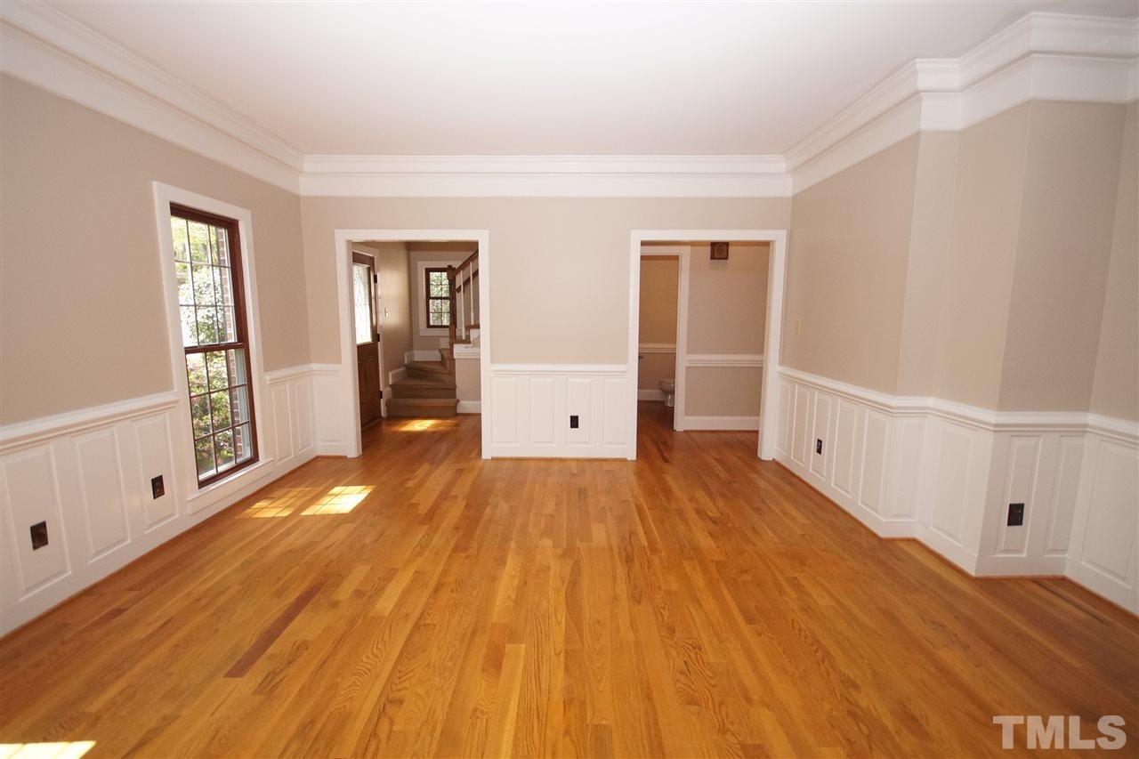 5012 Trail Ridge Drive Raleigh, NC 27613 - Photo 4 of 25 a view of an empty room with wooden floor and a window