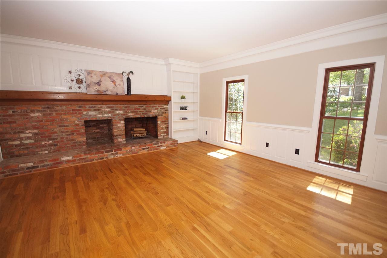 5012 Trail Ridge Drive Raleigh, NC 27613 - Photo 5 of 25 a view of empty room with fireplace and wooden floor