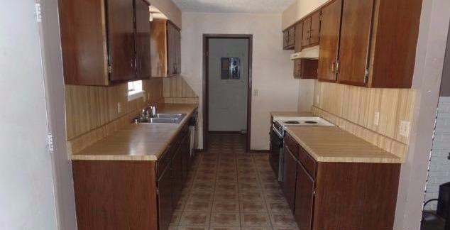 1506 Ave O Ralls, TX 79357 - Photo 6 of 10 a kitchen with a sink stove and mirror