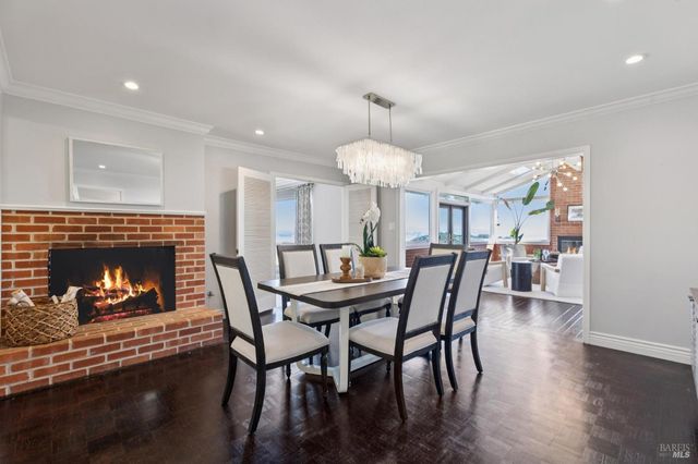 a living room with a fireplace and a floor to ceiling window
