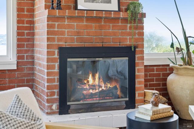 a living room with furniture floor to ceiling window and wooden floor