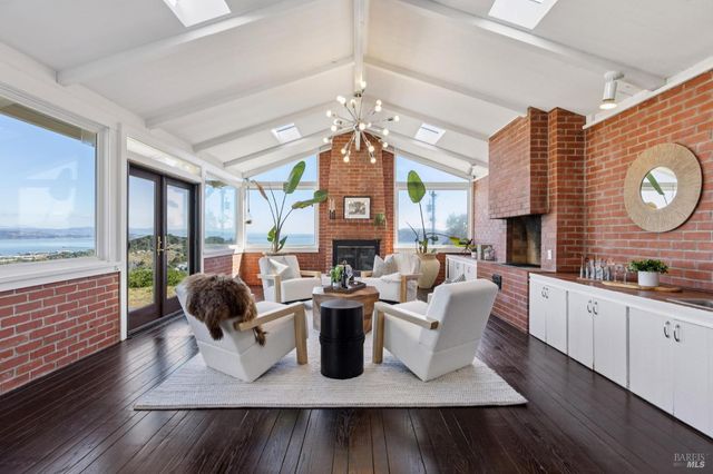 a living room with patio furniture and a fireplace