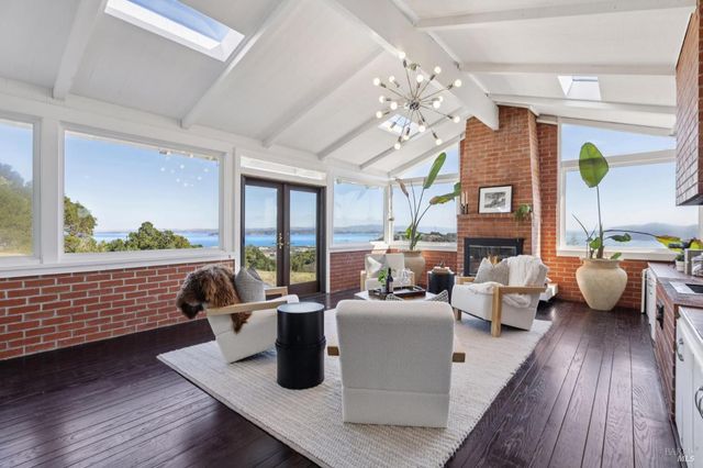 a living room with furniture or wooden floor and a large window