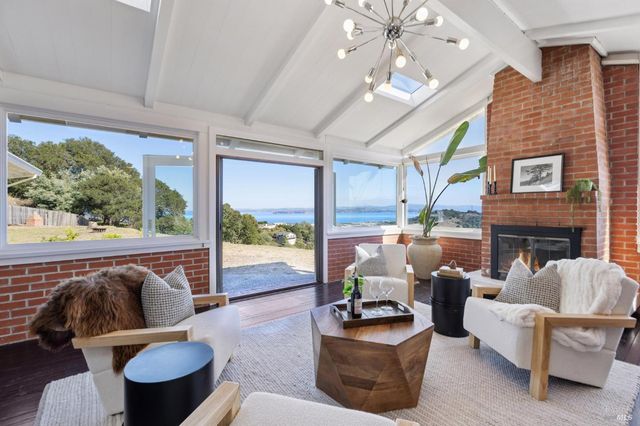 a kitchen with kitchen island a stove a refrigerator and a fireplace