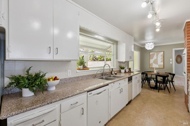 a kitchen with sink and cabinets