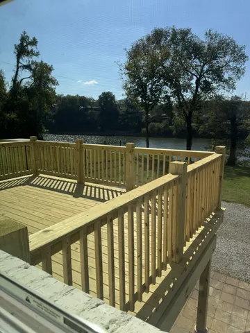 a view of balcony with wooden floor and fence