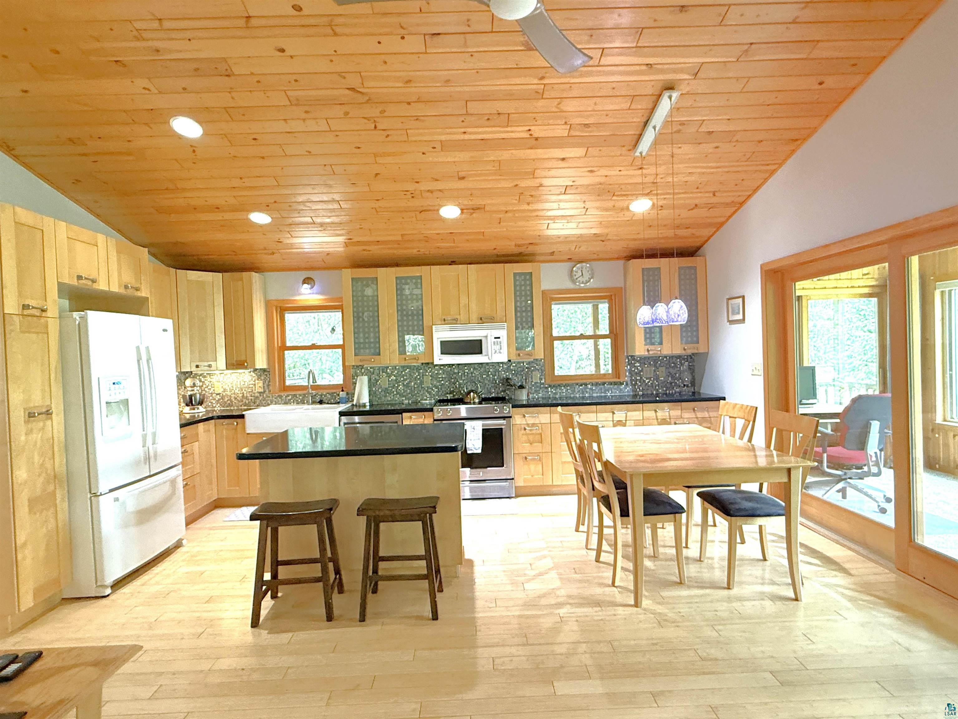 1787 North Bay Road Ely, MN 55731 - Photo 8 of 40 Kitchen featuring wood-finish cabinetry, black countertops, and a full suite of appliances