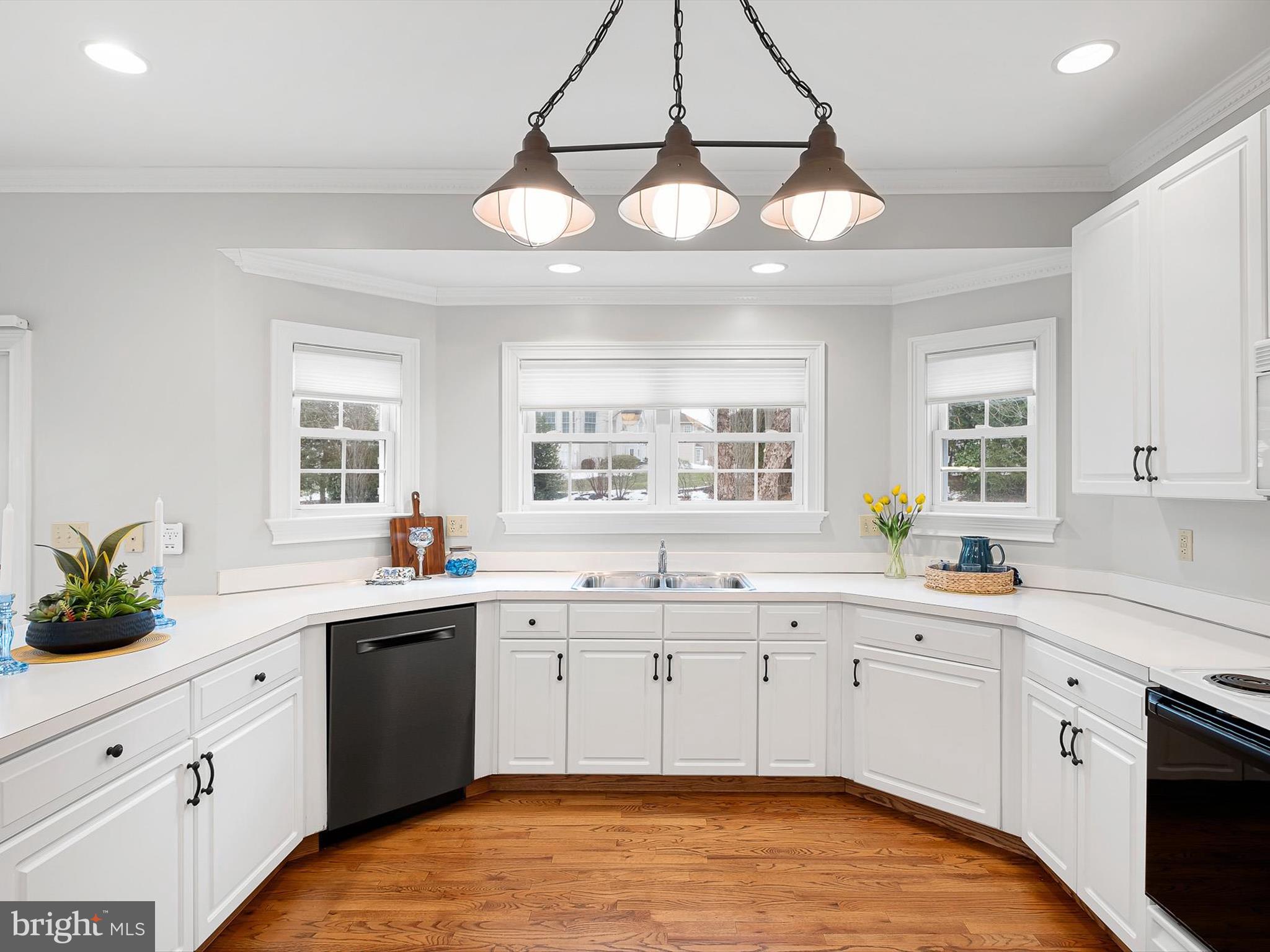 604 Oriole Place Hockessin, DE 19707 - Photo 13 of 40 a kitchen with a sink stove and cabinets