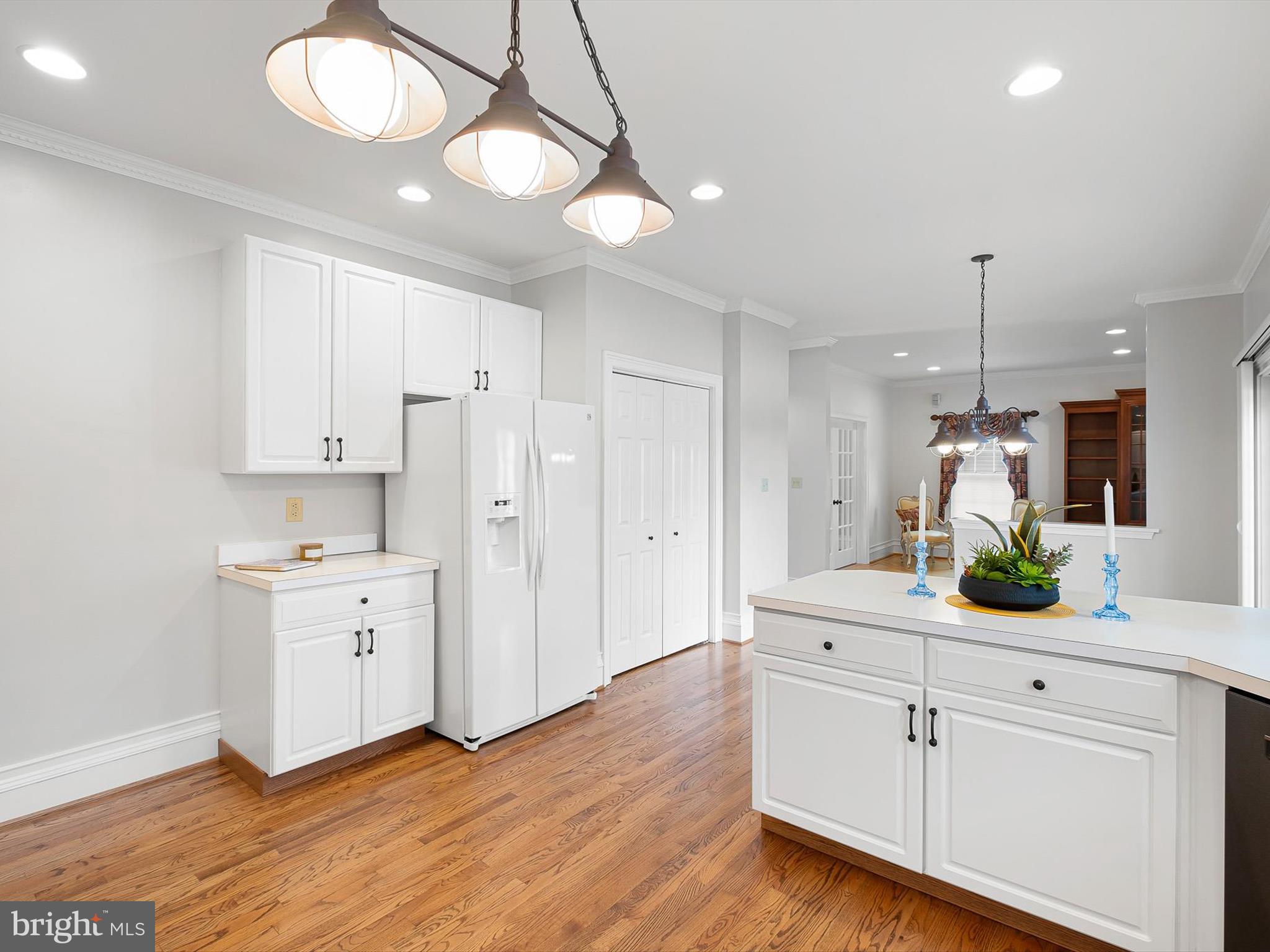 604 Oriole Place Hockessin, DE 19707 - Photo 15 of 40 a kitchen with white cabinets and refrigerator