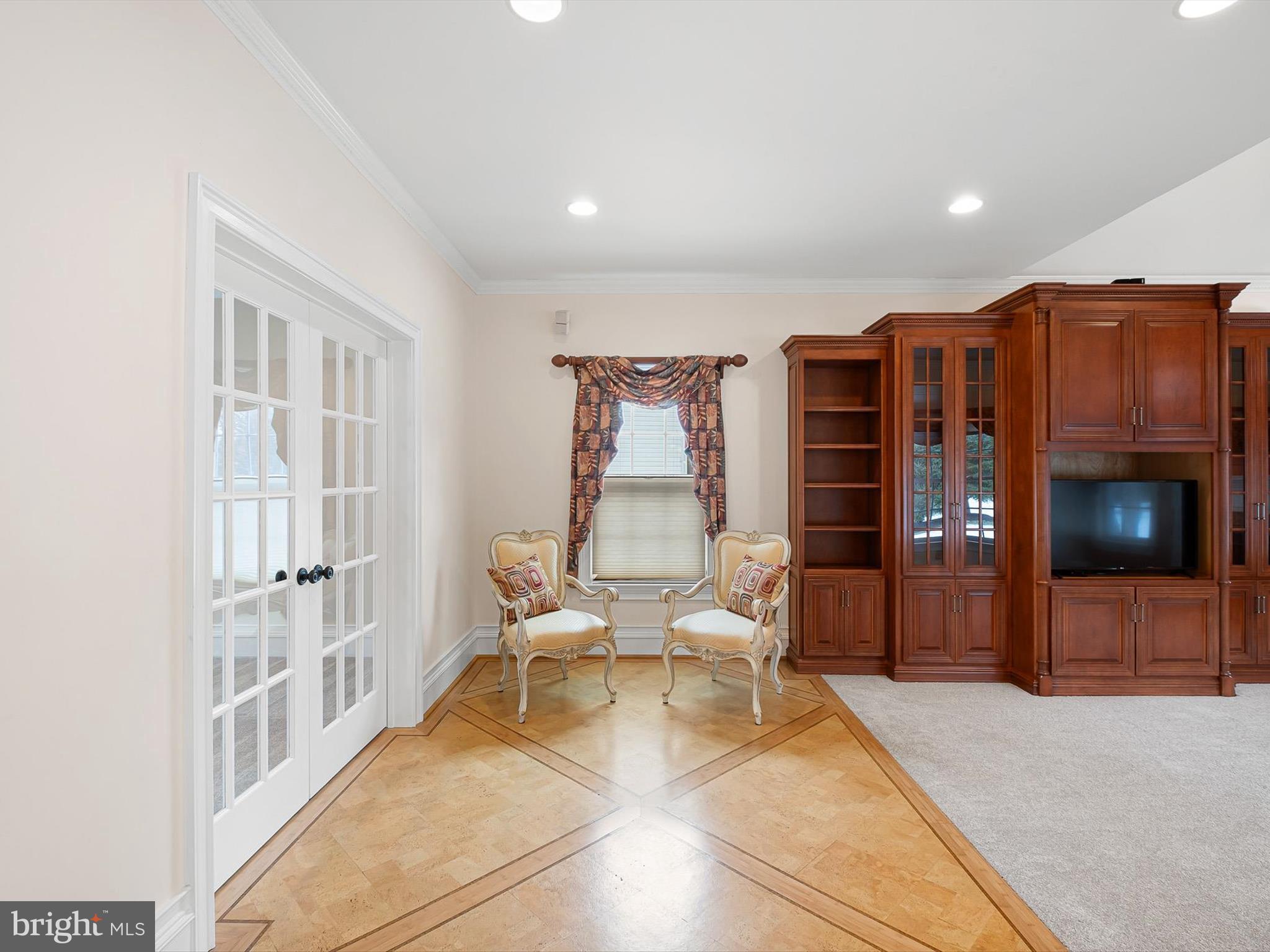 604 Oriole Place Hockessin, DE 19707 - Photo 16 of 40 a living room with furniture a flat screen tv and a fireplace