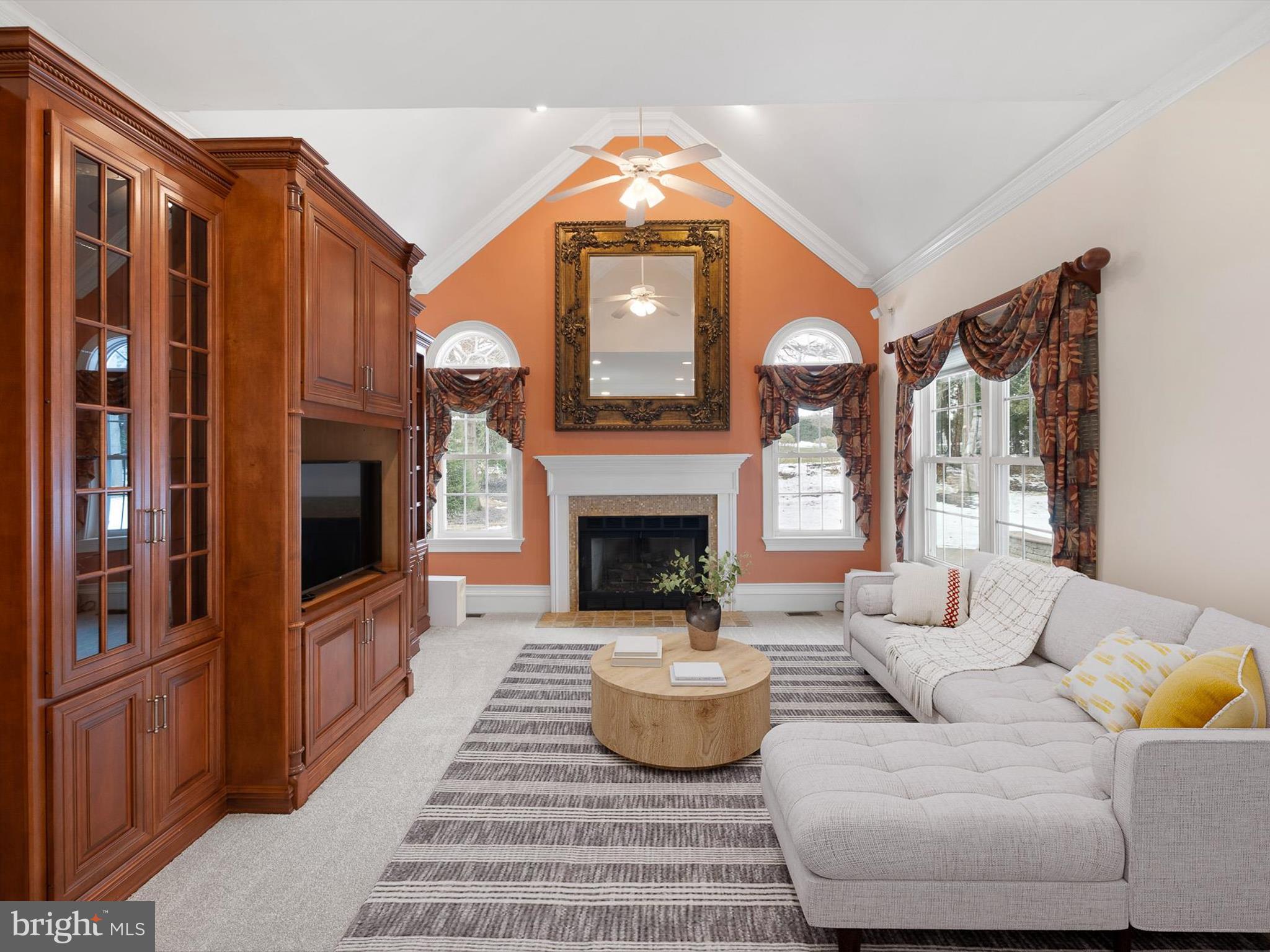 604 Oriole Place Hockessin, DE 19707 - Photo 19 of 40 a living room with furniture a fireplace and a flat screen tv