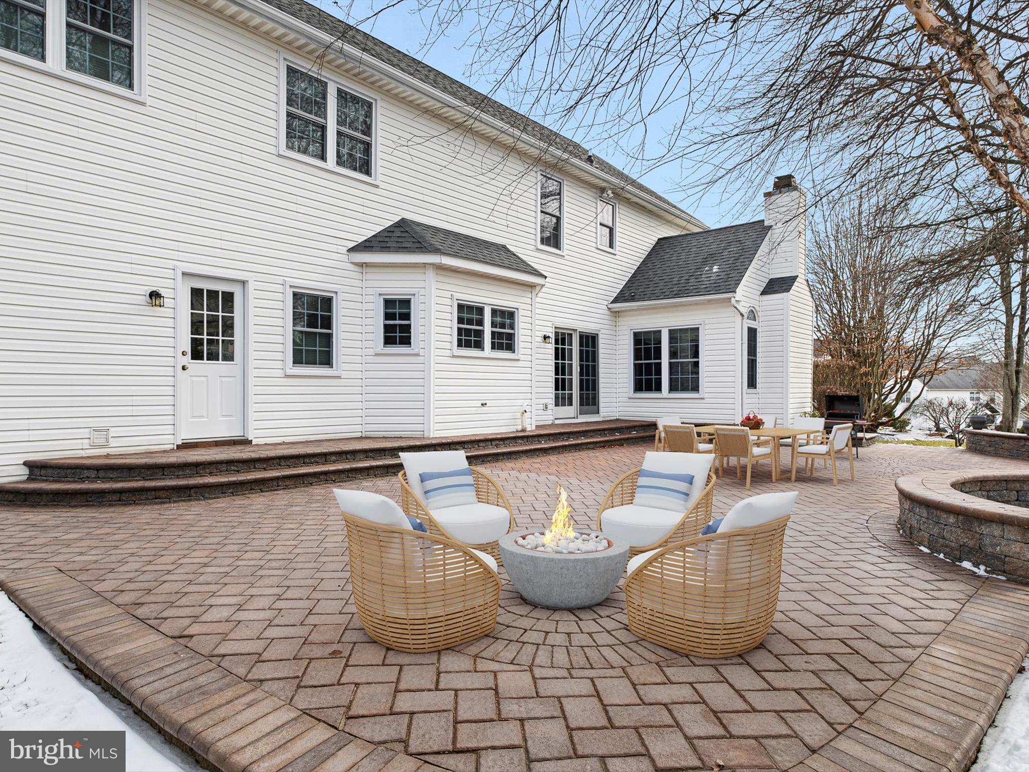 604 Oriole Place Hockessin, DE 19707 - Photo 20 of 40 a view of a white patio with couches chairs under an umbrella