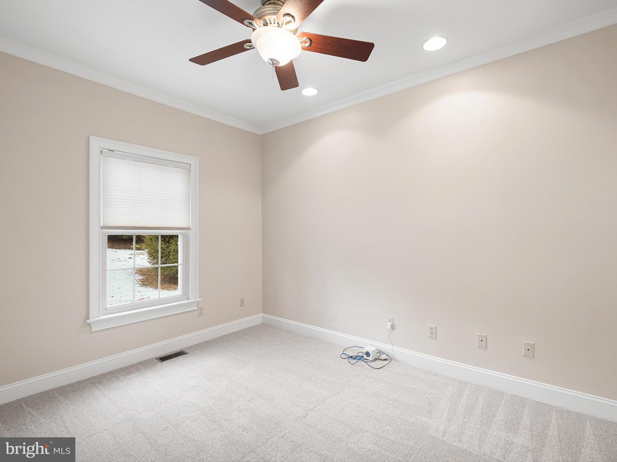 604 Oriole Place Hockessin, DE 19707 - Photo 24 of 40 an empty room with a window and a fan