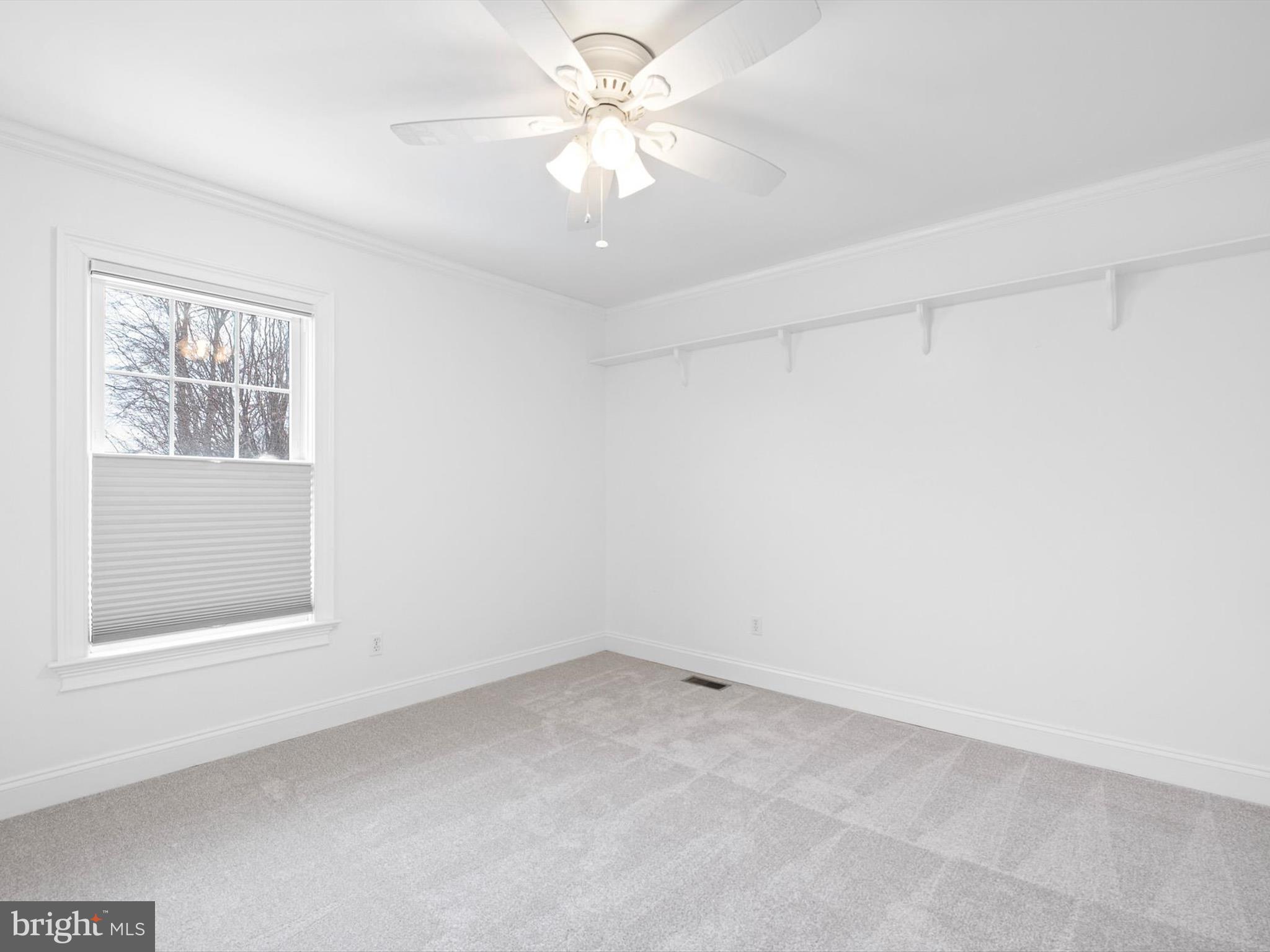 604 Oriole Place Hockessin, DE 19707 - Photo 36 of 40 an empty room with a window and a fan