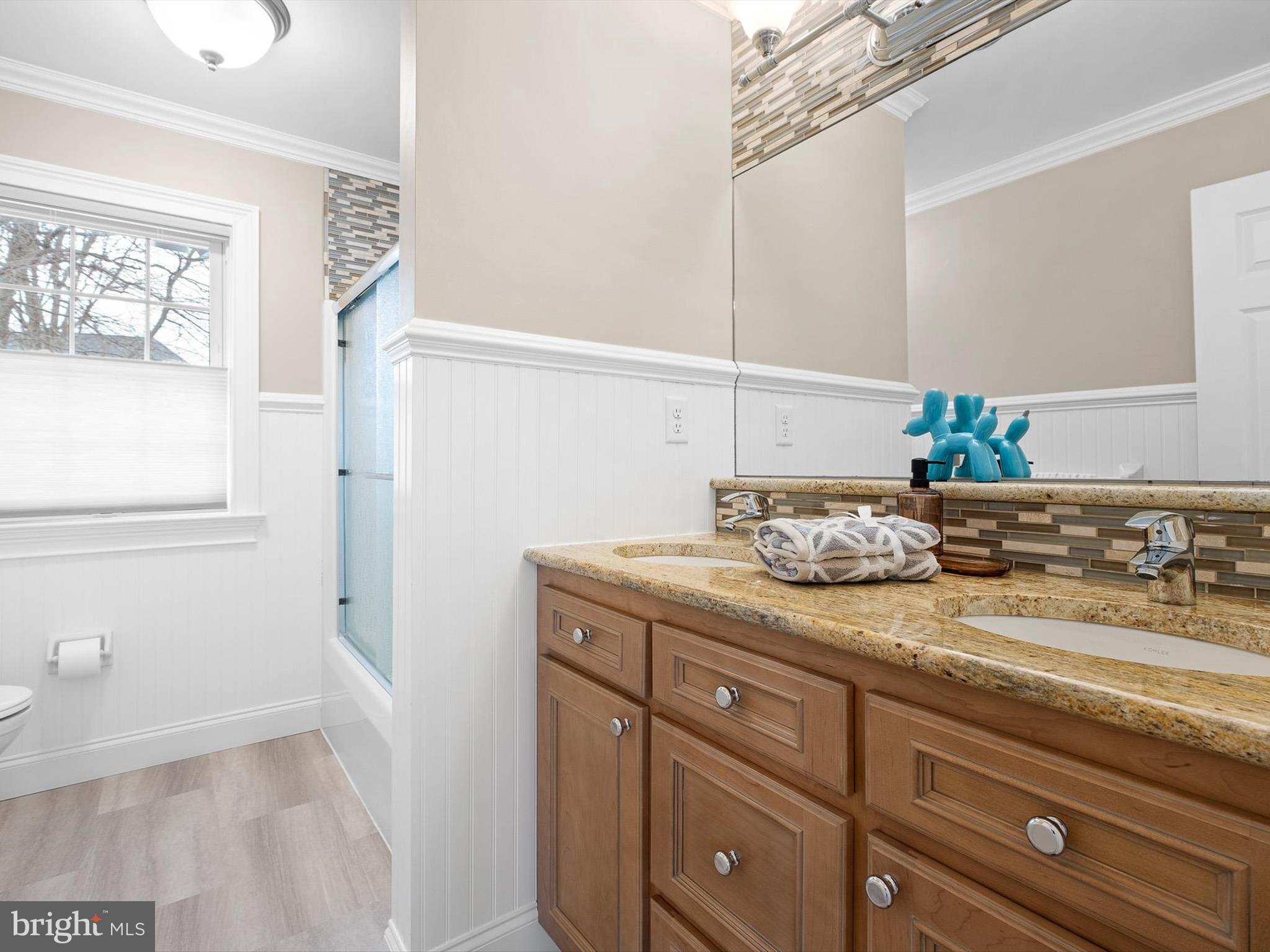 604 Oriole Place Hockessin, DE 19707 - Photo 37 of 40 a bathroom with a granite countertop sink and a mirror