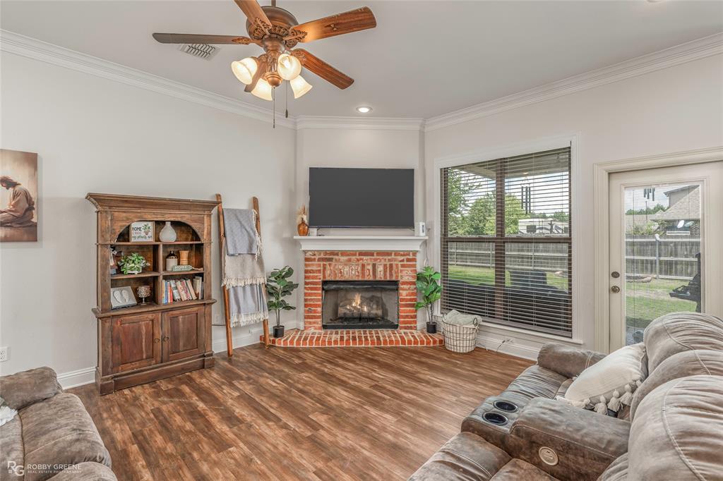 711 Reeds Reef Bossier City, LA 71112 - Photo 6 of 36 a living room with furniture a fireplace and a flat screen tv