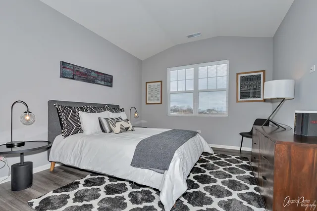 a bedroom with bed and a window