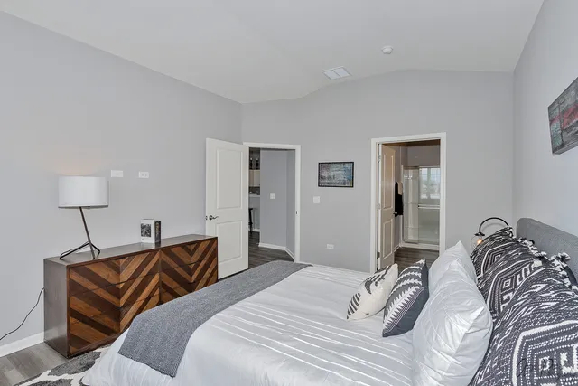 a bedroom with a bed and a lamp