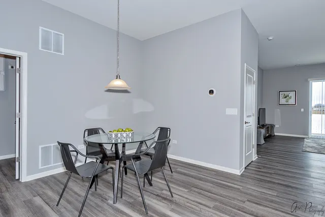 a view of a dining room with furniture and wooden floor