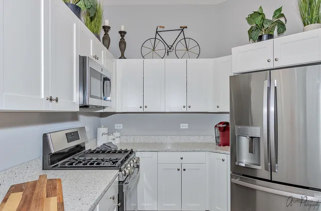 a kitchen with stainless steel appliances a refrigerator sink and cabinets