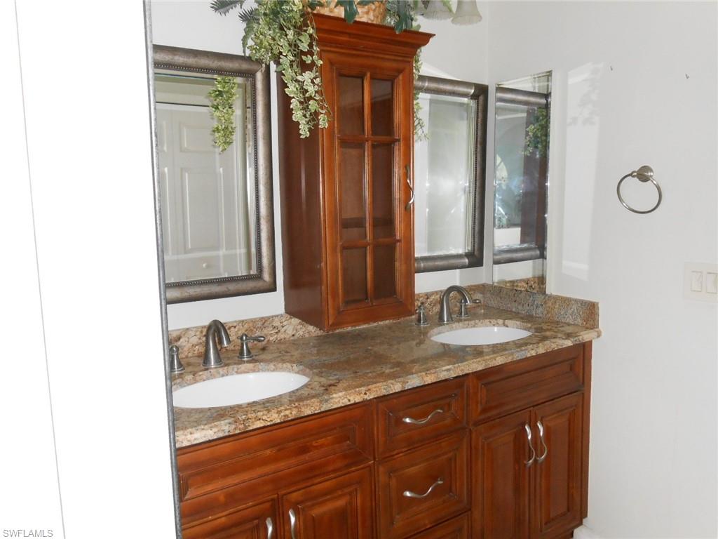 18331 Useppa Road Fort Myers, FL 33967 - Photo 7 of 15 a bathroom with a granite countertop sink and a mirror