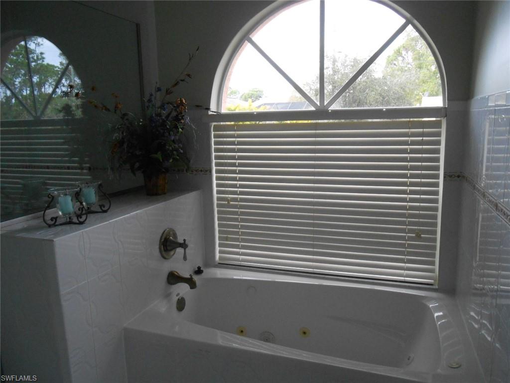 18331 Useppa Road Fort Myers, FL 33967 - Photo 8 of 15 a bathroom with a bathtub and a window