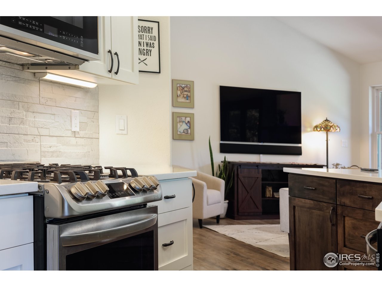 187 Wichita Road Lyons, CO 80540 - Photo 11 of 47 a kitchen with a stove and a microwave