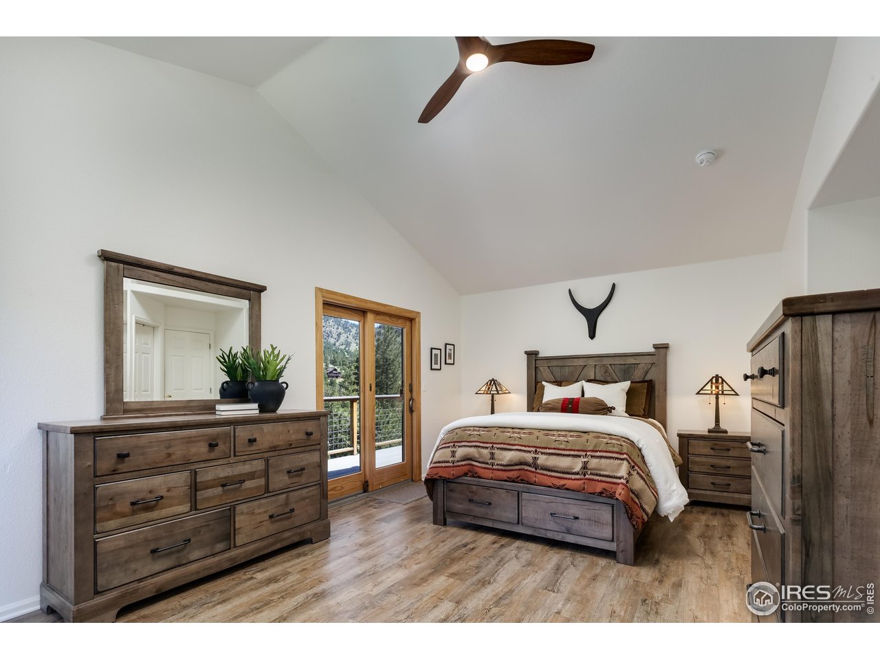 187 Wichita Road Lyons, CO 80540 - Photo 16 of 47 a bedroom with a bed and a dresser