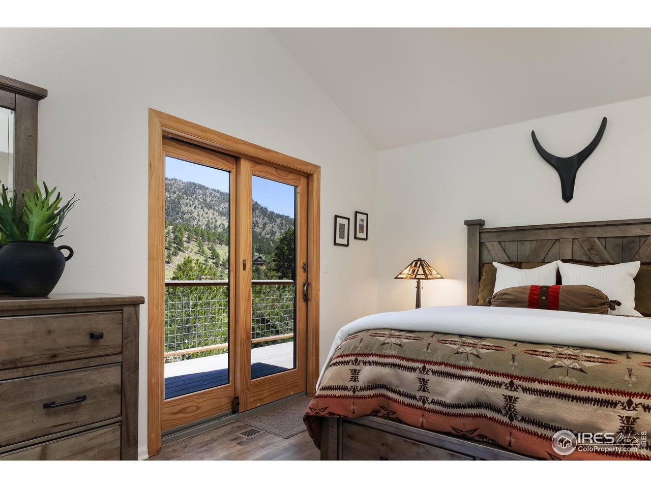 187 Wichita Road Lyons, CO 80540 - Photo 17 of 47 a bedroom with a bed and a window