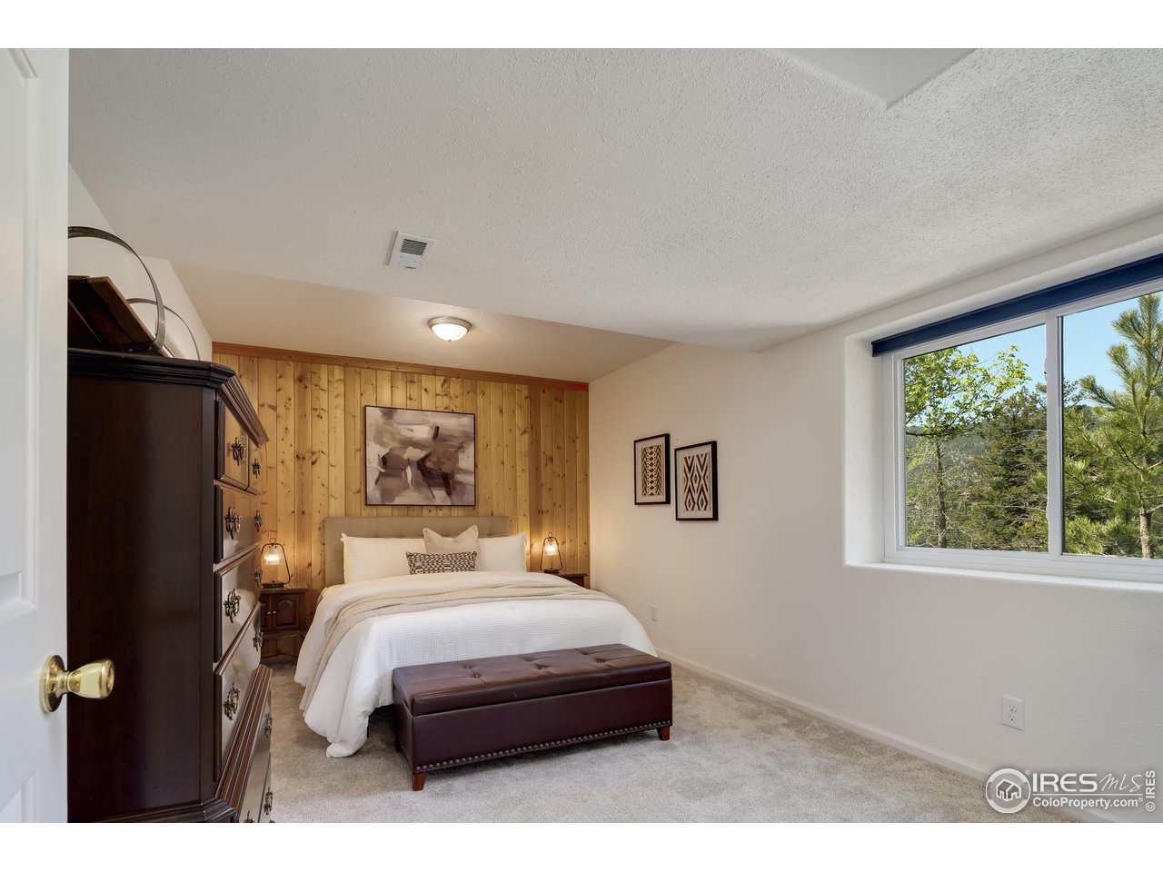 187 Wichita Road Lyons, CO 80540 - Photo 25 of 47 a bedroom with a large bed and a window
