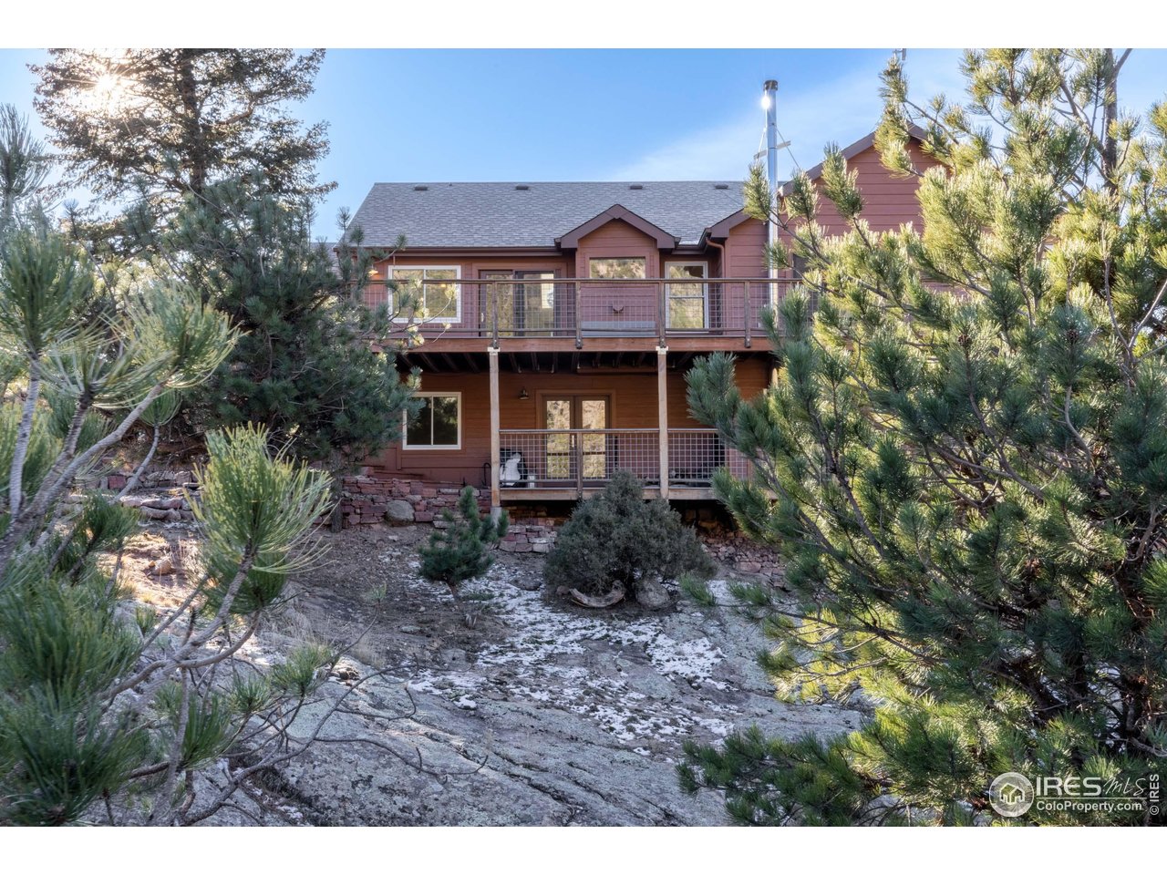 187 Wichita Road Lyons, CO 80540 - Photo 42 of 47 a front view of a house with garden