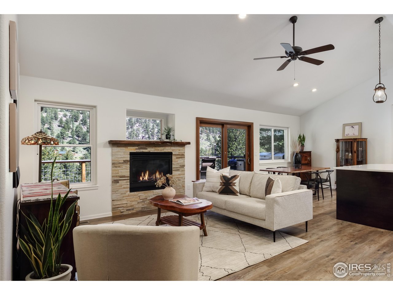 187 Wichita Road Lyons, CO 80540 - Photo 6 of 47 a living room with furniture a fireplace and a large window