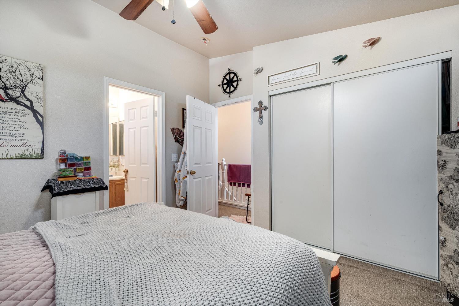 590 Laurel Grove Circle Santa Rosa, CA 95407 - Photo 18 of 44 a bedroom with a bed and a chandelier