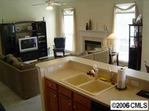 6506 Elfreda Road Charlotte, NC 28270 - Photo 2 of 8 a kitchen with a sink a stove and a microwave