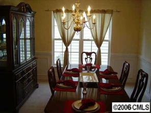 6506 Elfreda Road Charlotte, NC 28270 - Photo 4 of 8 a view of a dining room with furniture and a chandelier