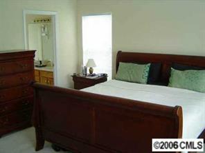 6506 Elfreda Road Charlotte, NC 28270 - Photo 5 of 8 a bedroom with a bed and a dresser