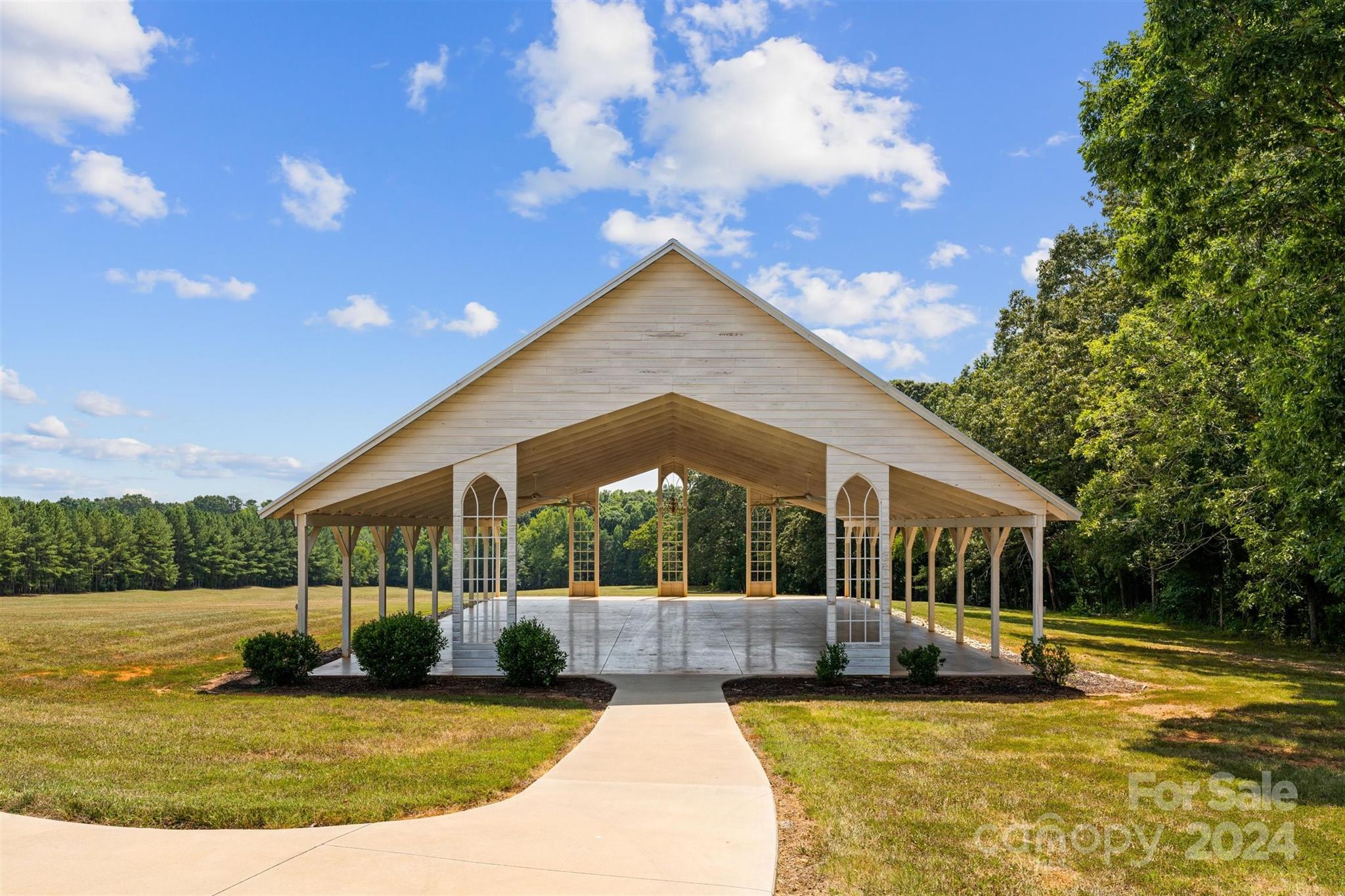 7755 Stokes Ferry Road Salisbury, NC 28146 - Photo 25 of 47 a view of swimming pool with lawn chairs and large trees