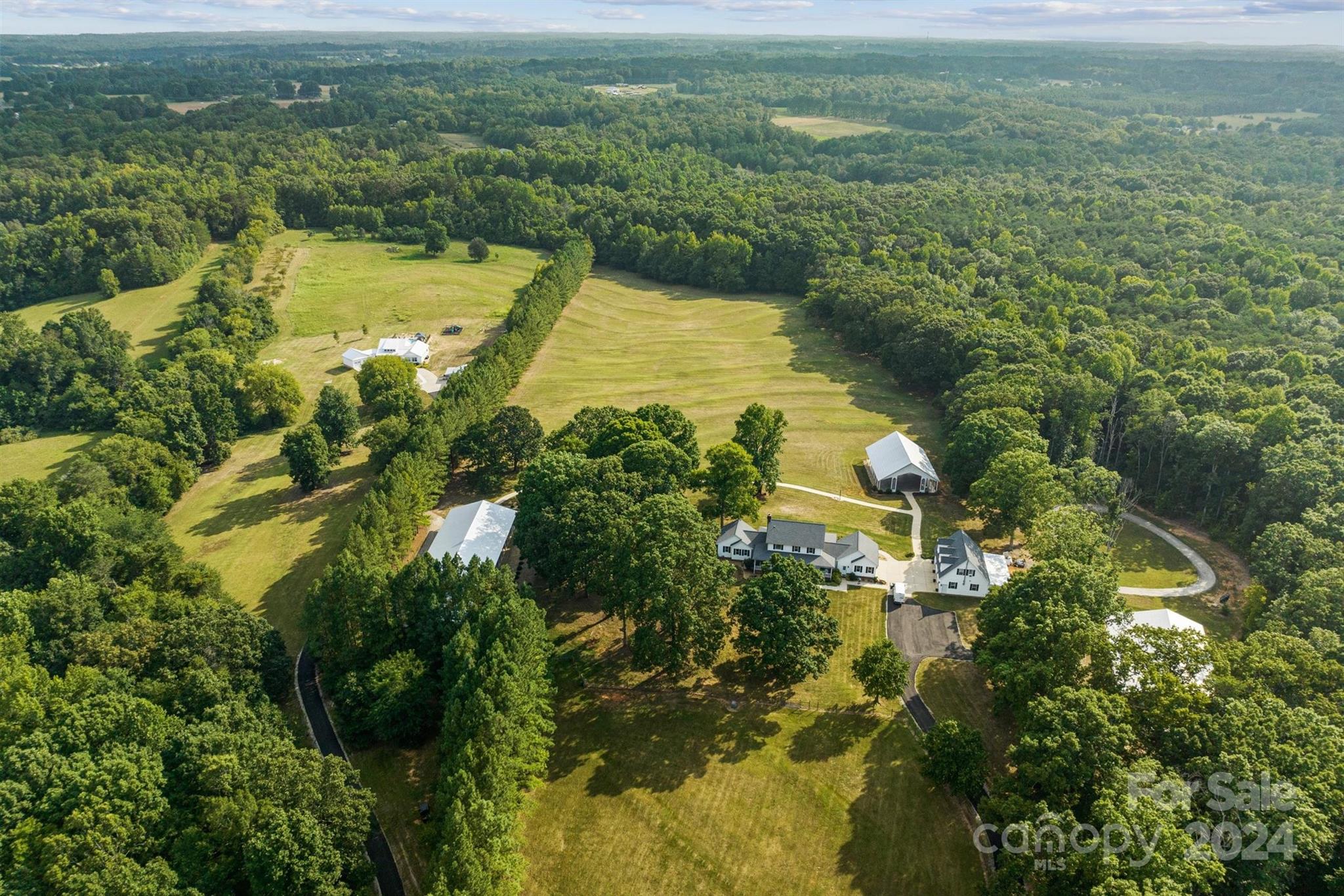 7755 Stokes Ferry Road Salisbury, NC 28146 - Photo 46 of 47 an aerial view of residential houses with outdoor space and trees