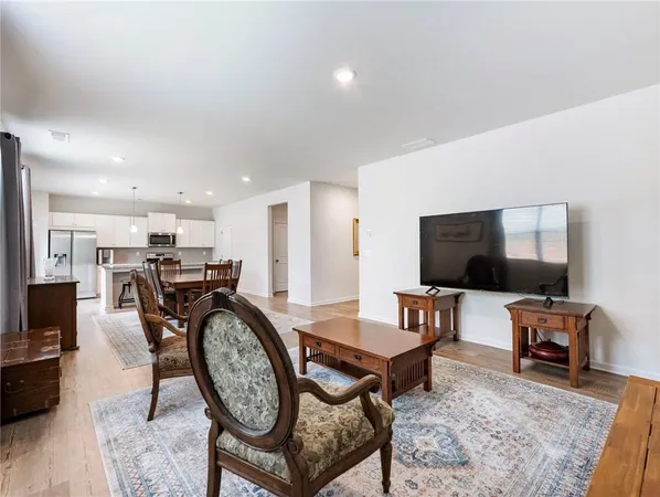 a view of a livingroom with furniture and a flat screen tv