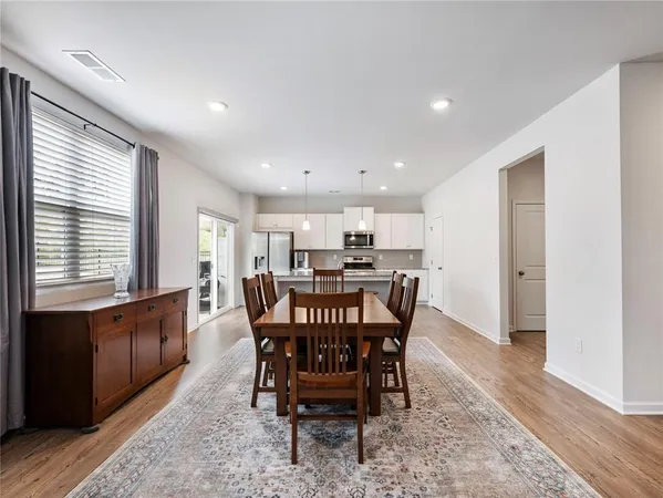 a view of a dining room with furniture window and wooden floor